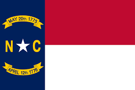 North Carolina state flag featuring a blue vertical stripe with a white star and dates inscribed, alongside red and white horizontal stripes.